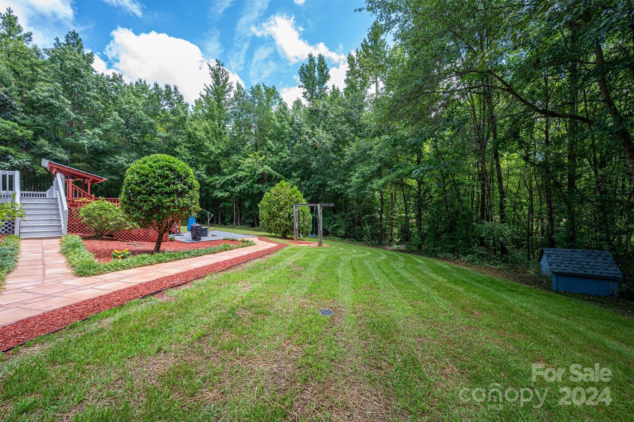 459 Patrick Road Gastonia, NC 28056 - Photo 35 of 39 a view of a backyard with potted plants and large trees