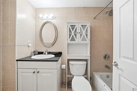 a bathroom with a toilet a sink and a mirror