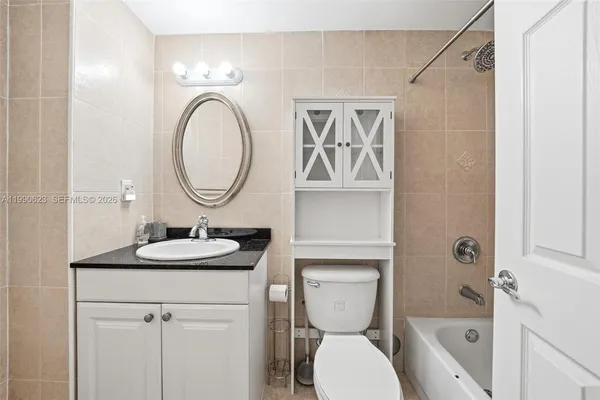 a bathroom with a toilet a sink and a mirror