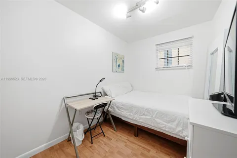 a bedroom with a bed and a table in it