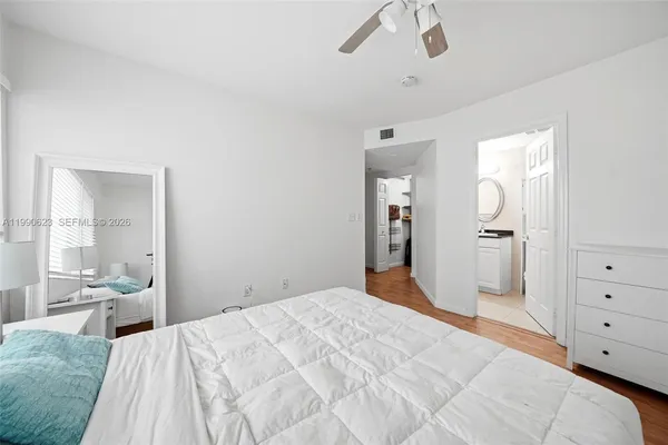 a bedroom with a large bed and chandelier
