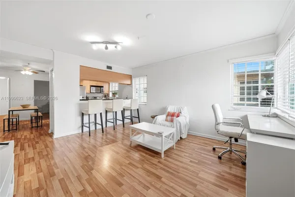 a living room with furniture and wooden floor