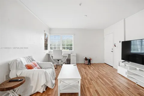 a bedroom with two beds and a flat screen tv