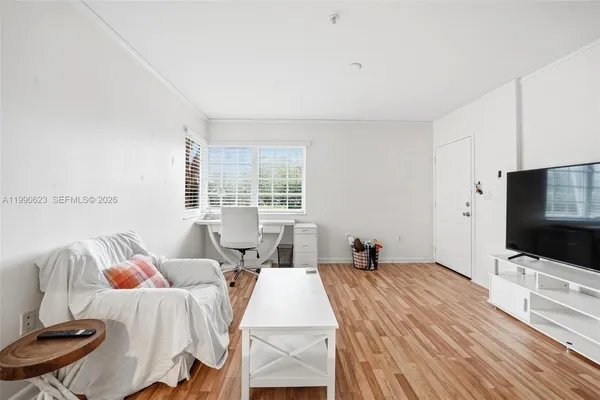 a bedroom with two beds and a flat screen tv