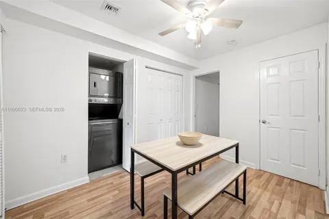 a view of a room with furniture and wooden floor