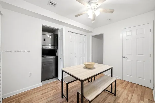 a view of a room with furniture and wooden floor
