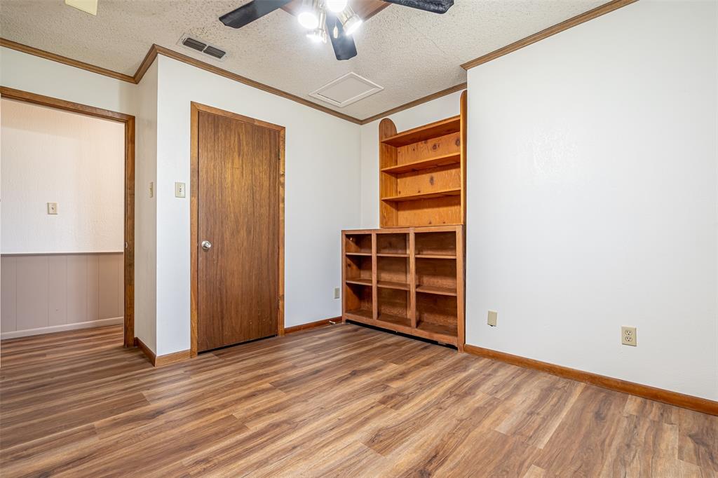 501 Endora Dublin, TX 76446 - Photo 27 of 39 an empty room with wooden floor closet and windows