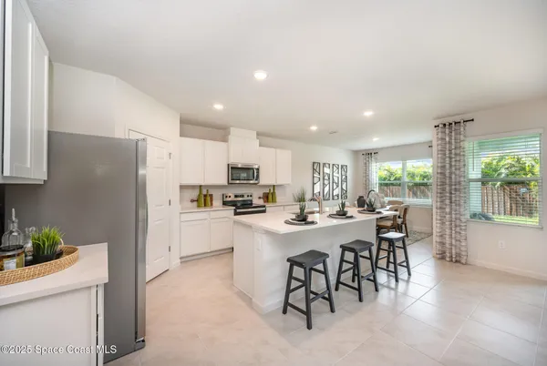 a kitchen with a sink appliances and cabinets