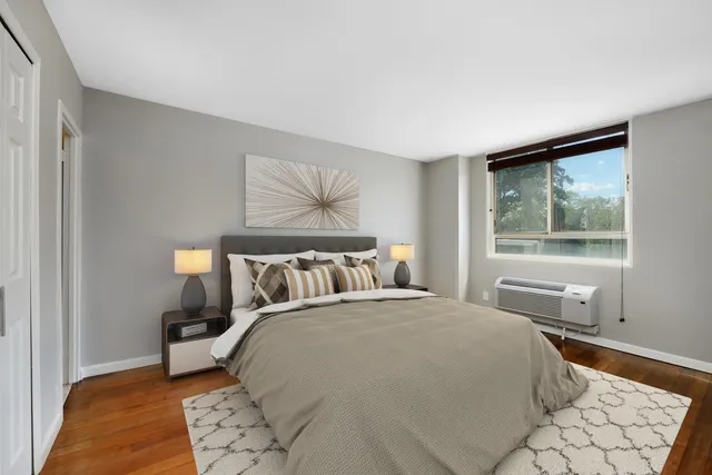 a bedroom with a large bed and a window