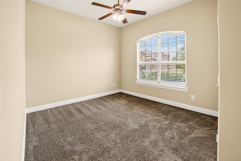 552 Winnetka Drive Oak Point, TX 75068 - Photo 6 of 40 an empty room with a window and a fan