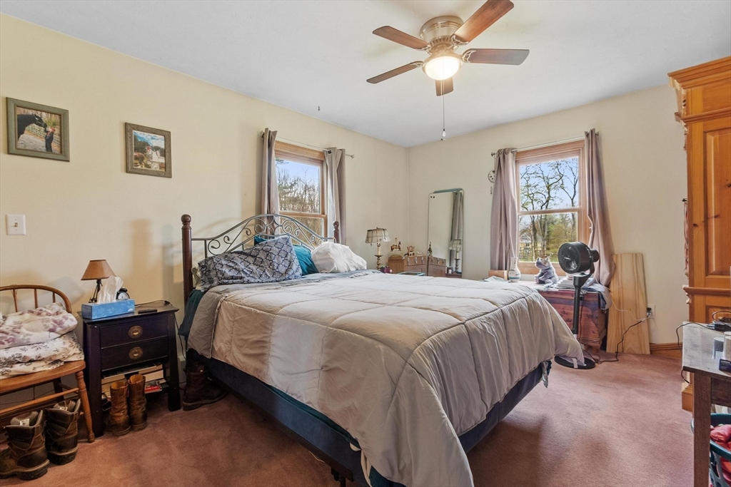 340 Ball Hill Road Princeton, MA 01541 - Photo 29 of 41 a bedroom with a bed and a chandelier