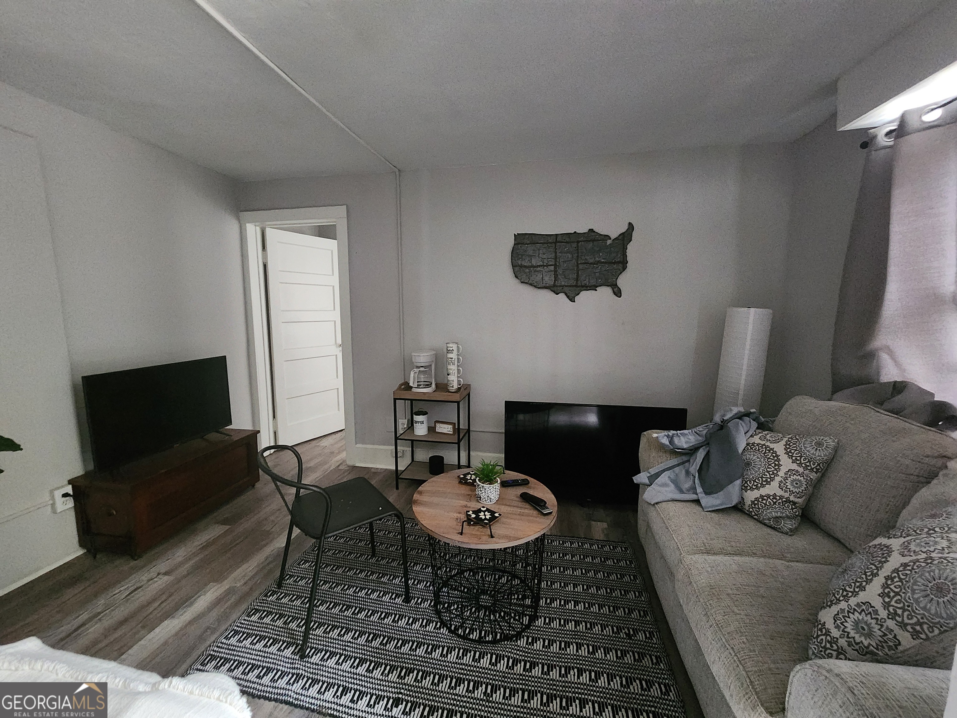 917 Oakview Avenue, Unit 6 Columbus, GA 31906 - Photo 12 of 13 a living room with furniture a flat screen tv and a fireplace