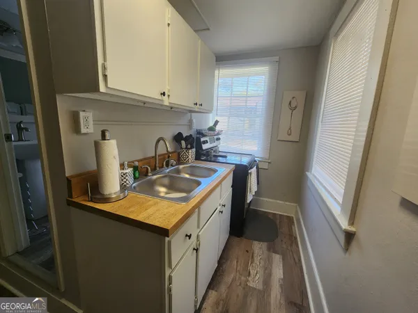 a kitchen with sink cabinets and stove