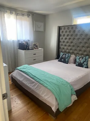 a bedroom with a bed and window