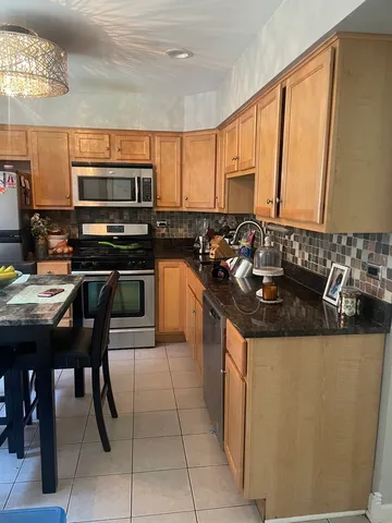 a kitchen with stainless steel appliances granite countertop a sink and cabinets