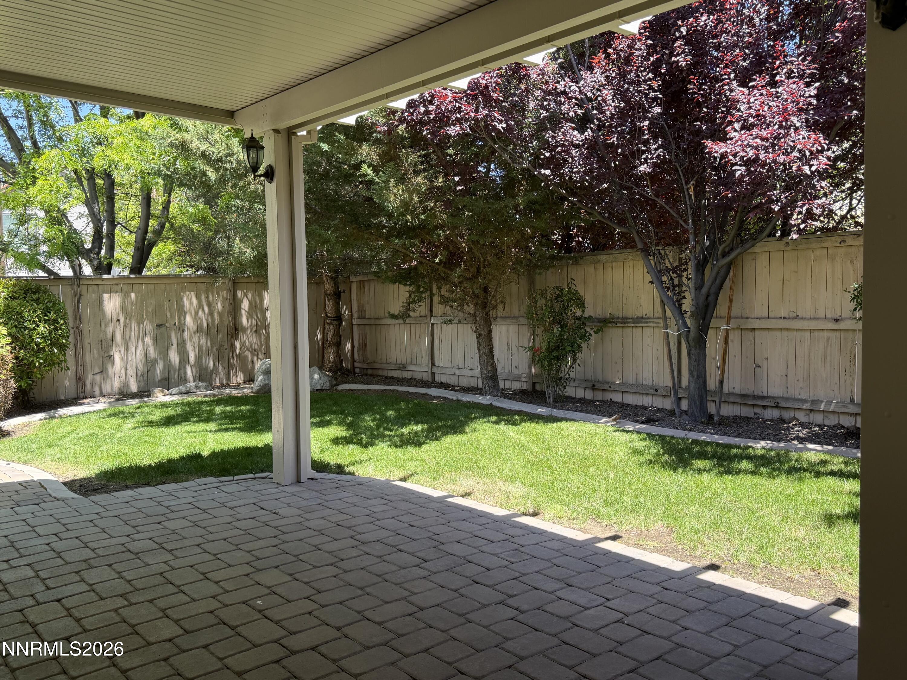 10890 Oakhaven Drive Reno, NV 89521 - Photo 26 of 28 a backyard of a house with a garden and tree