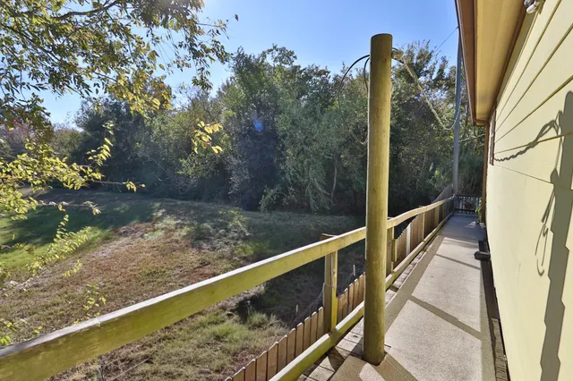 a view of a balcony with yard