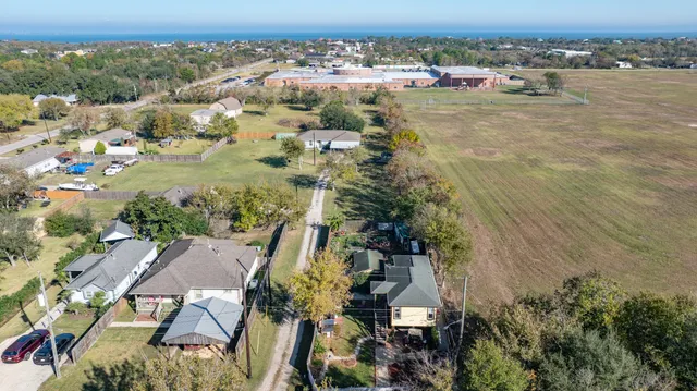 an aerial view of a house with a yard