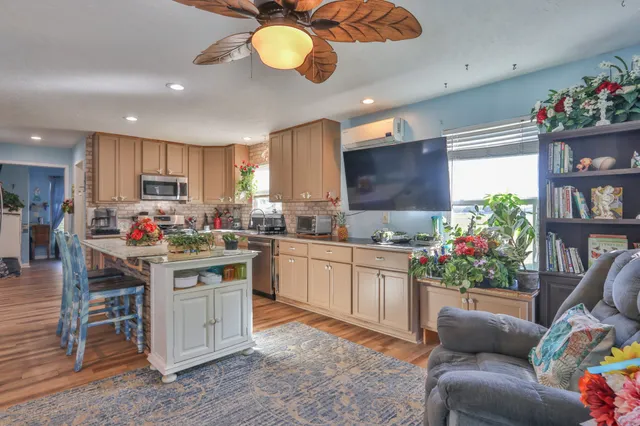 a kitchen with stainless steel appliances granite countertop a refrigerator and a stove top oven