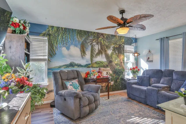 a living room with furniture and flowers
