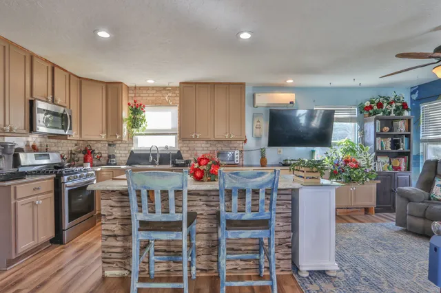 a kitchen with furniture wooden floor and a window