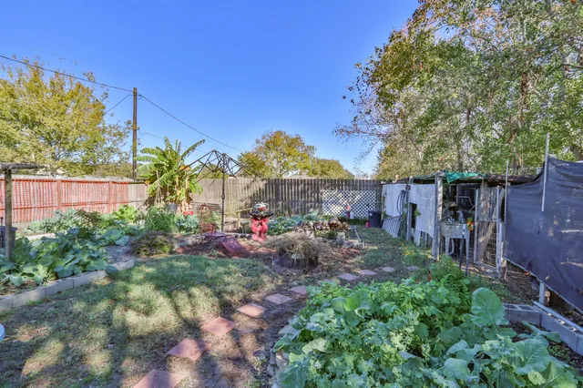 a view of a house with a yard and garden