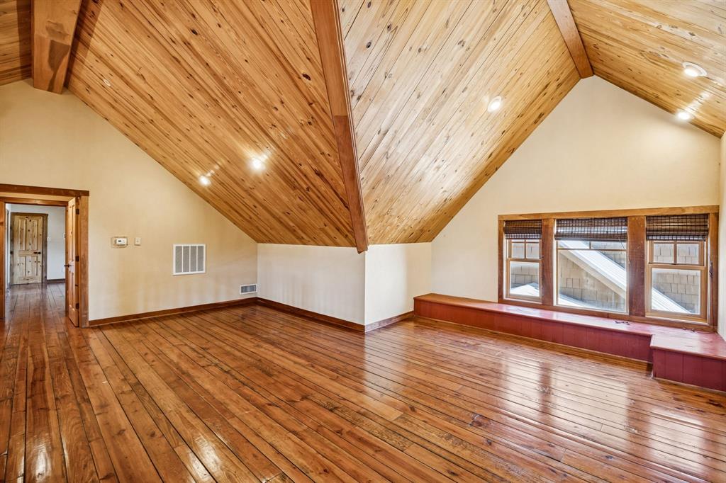 1922 A Bethel-Cannon Road Whitewright, TX 75491 - Photo 19 of 40 Spacious room featuring rich wood-finish flooring and a vaulted wood-paneled ceiling