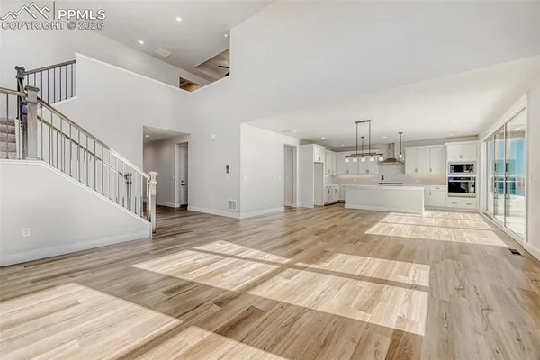 a view of kitchen with sink and refrigerator
