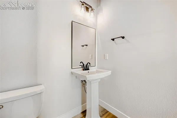 a bathroom with a sink a toilet and mirror