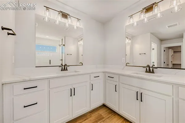 a bathroom with a double vanity sink and mirror
