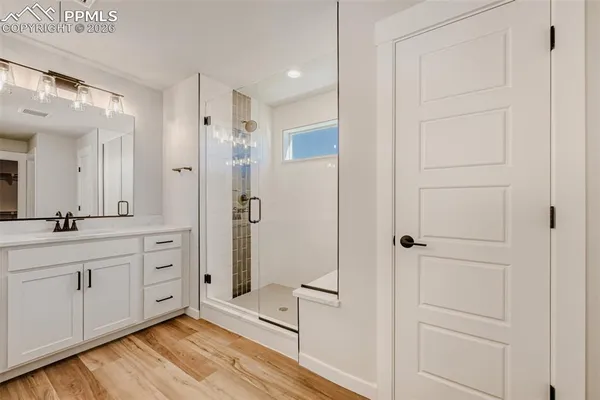 a spacious bathroom with a shower and a sink