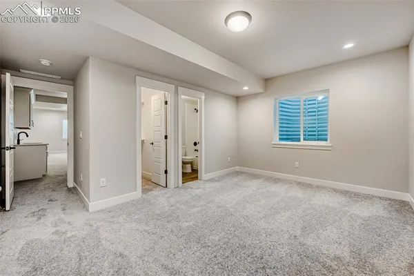 an empty room with windows and closet