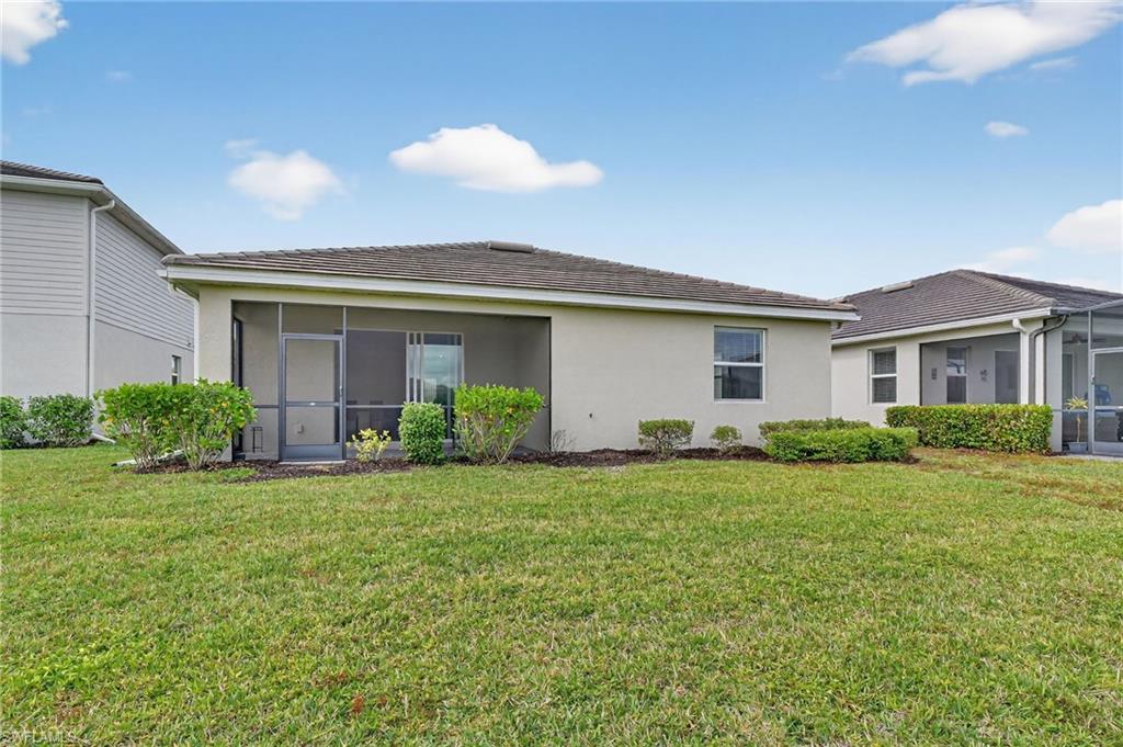 2126 Hamlin Street Naples, FL 34120 - Photo 26 of 38 a front view of house with yard and green space