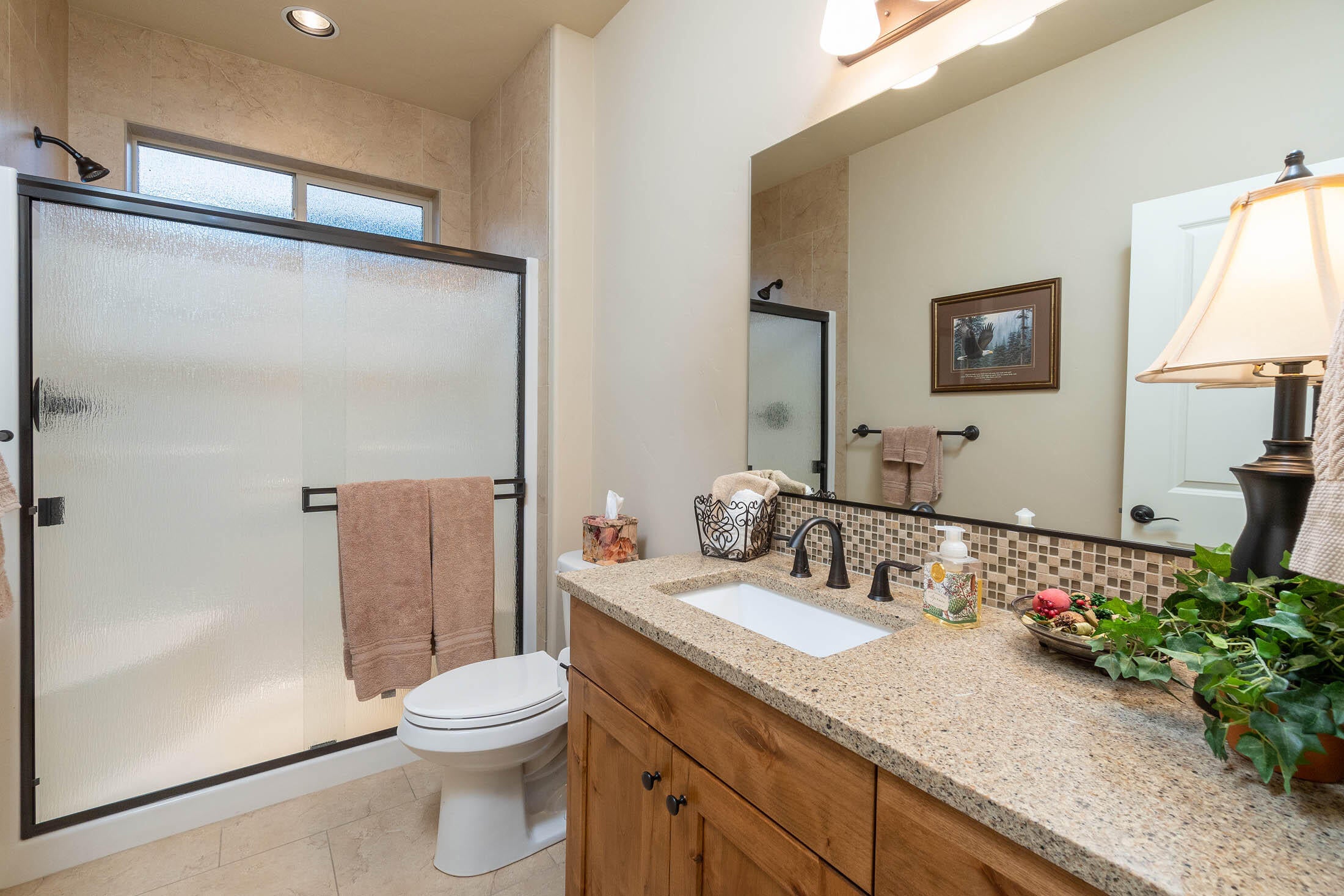 61129 Manhae Loop Bend, OR 97702 - Photo 17 of 44 3rd bath with tile surround shower and matching tile flooring.