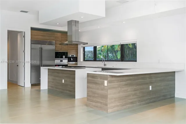 an empty room with a window and wooden floor