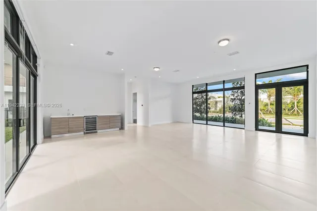 a work room with furniture and a floor to ceiling window
