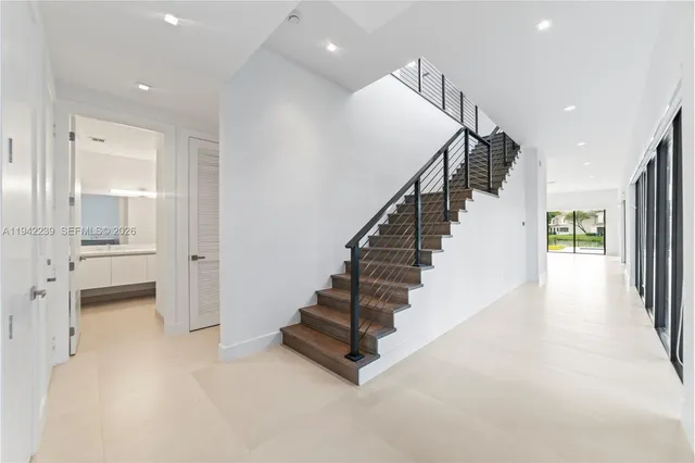 a front view of a house with a yard and trees