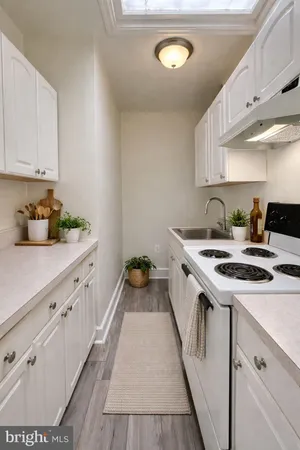 a kitchen with a sink stove and cabinets