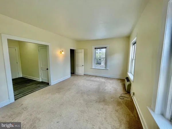 a view of an empty room and a window