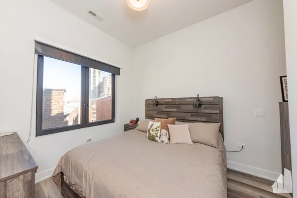 a bedroom with a bed and a window