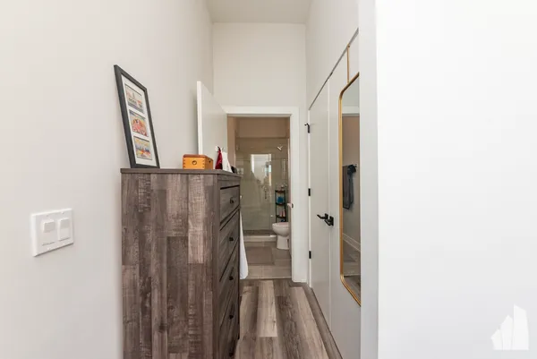 a view of a hallway with wooden floor
