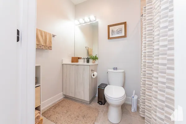 a white toilet sitting next to a bathroom sink