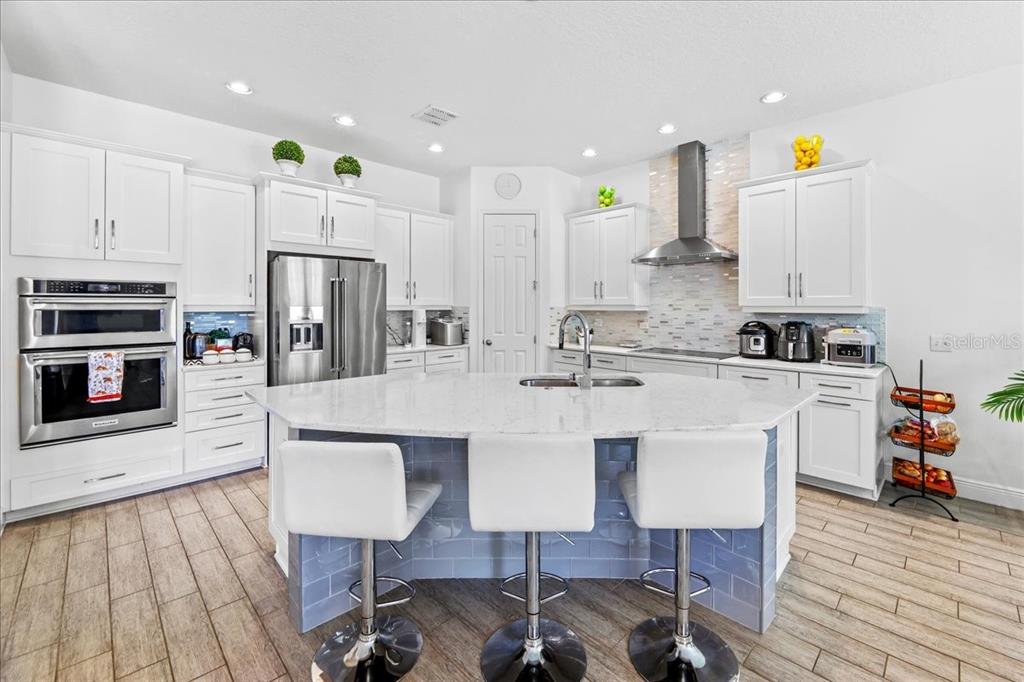 8746 Crescendo Avenue Windermere, FL 34786 - Photo 17 of 56 a kitchen with stainless steel appliances a dining table chairs microwave and sink