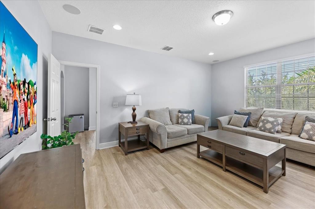 8746 Crescendo Avenue Windermere, FL 34786 - Photo 18 of 56 a living room with furniture and a flat screen tv