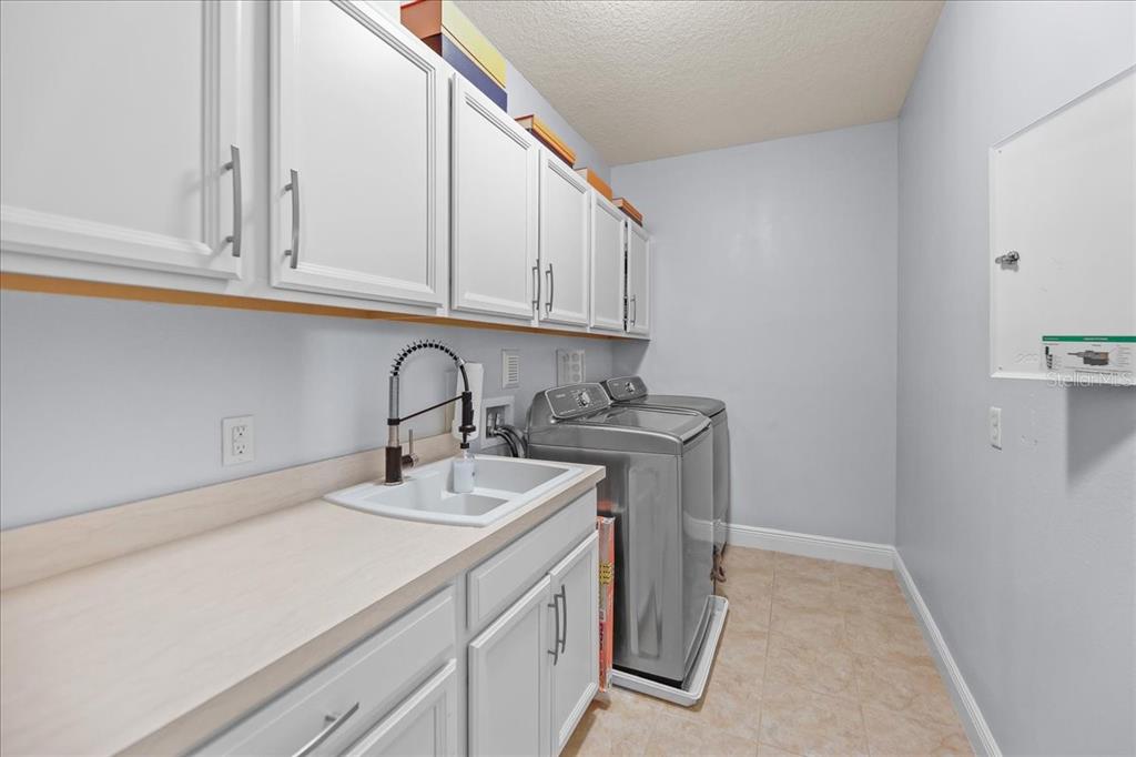 8746 Crescendo Avenue Windermere, FL 34786 - Photo 24 of 56 a utility room with sink dryer and washer