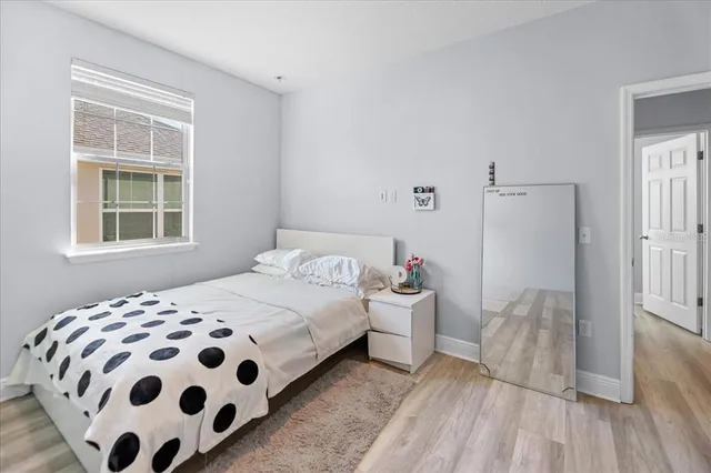 a bedroom with a bed and a chair