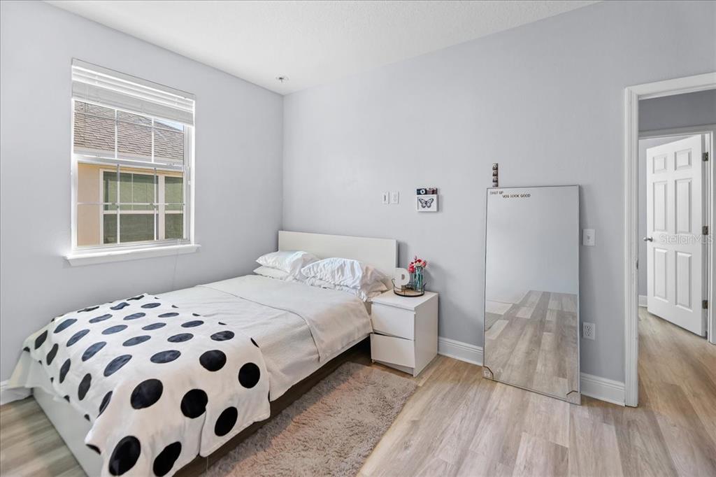 8746 Crescendo Avenue Windermere, FL 34786 - Photo 25 of 56 a bedroom with a bed and a window