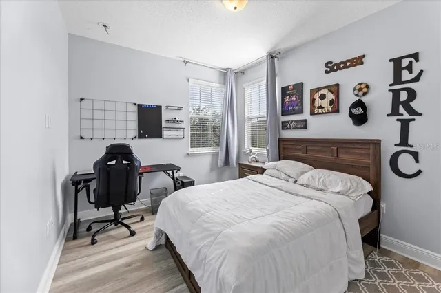 a bedroom with a bed a mirror and a window