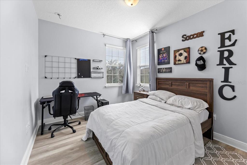 8746 Crescendo Avenue Windermere, FL 34786 - Photo 27 of 56 a bedroom with a bed and a chair