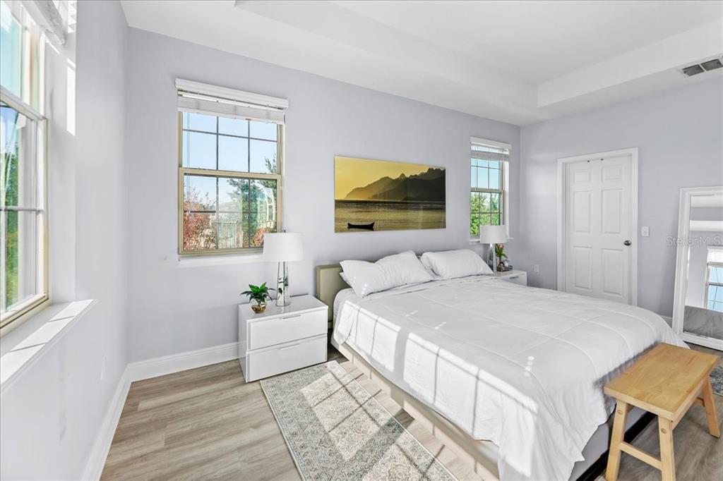 8746 Crescendo Avenue Windermere, FL 34786 - Photo 29 of 56 a bedroom with a bed a mirror and a window